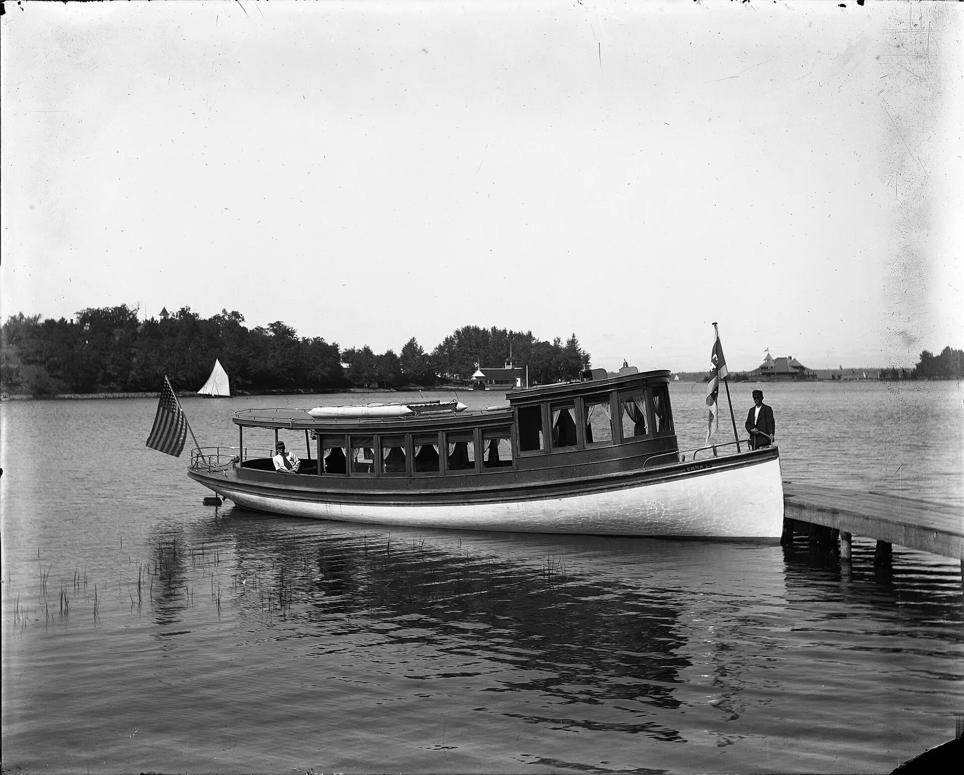 A historic photograph of the gasoline launch Emma Lin at a dock on Deephaven Bay