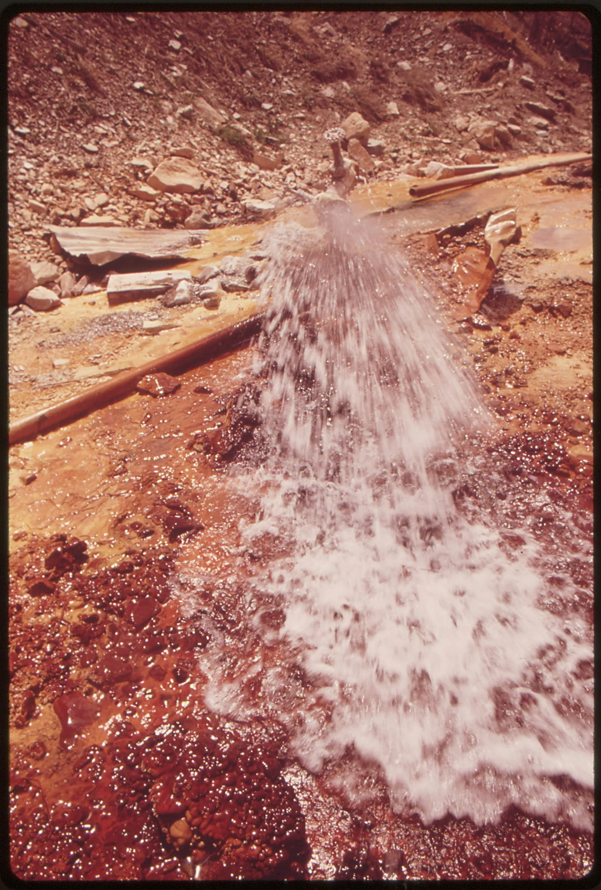 Iron-rich well water staining the ground rust-orange