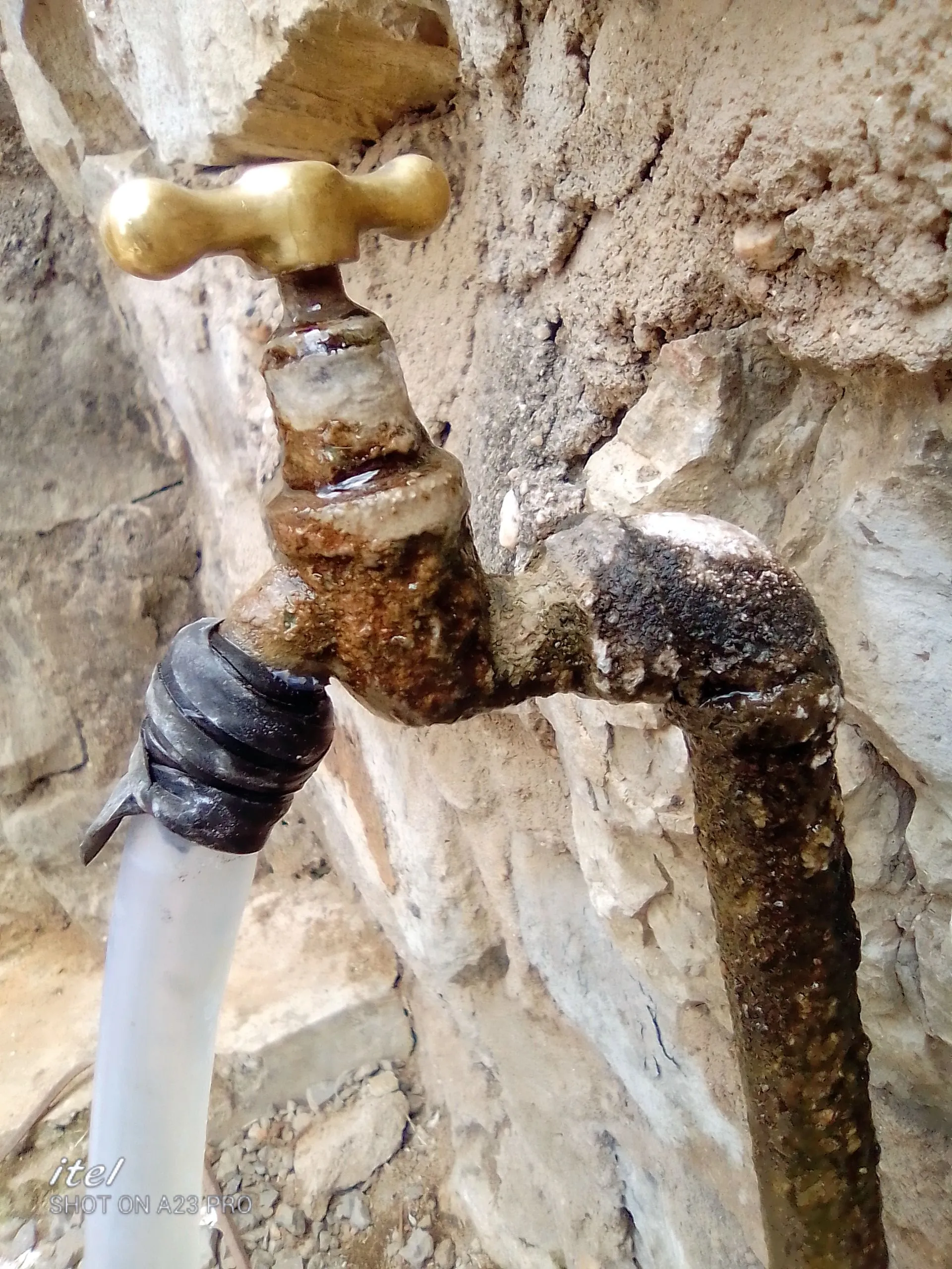 A corroded brass tap with mineral buildup