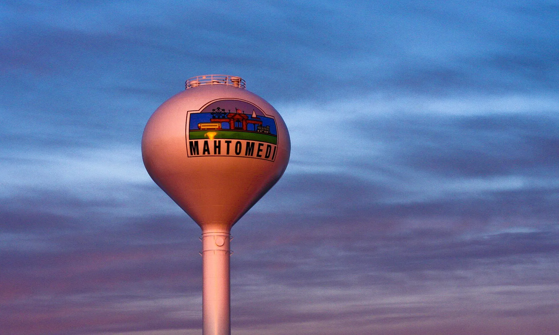 The Mahtomedi water tower against a purple sunset sky