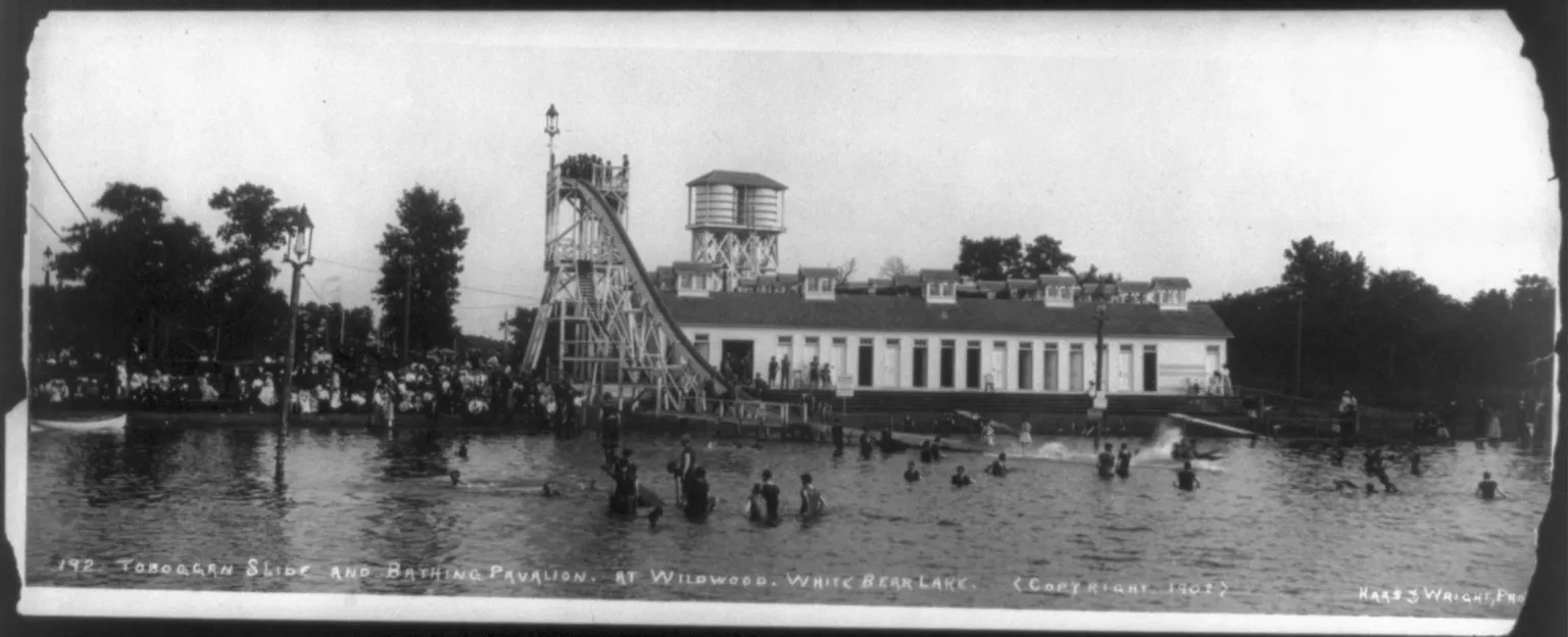 A historic photo of bathing pavilions and swimmers on White Bear Lake at Mahtomedi