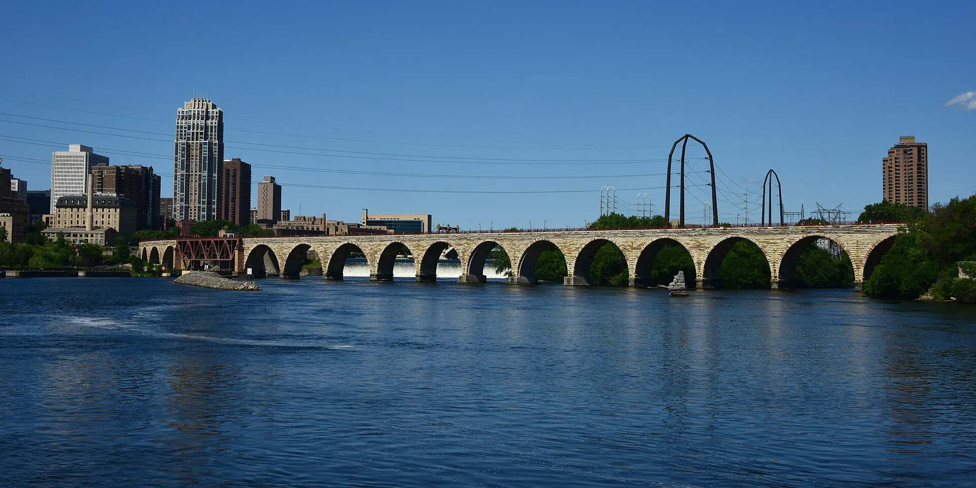The Stone Arch Bridge crossing the Mississippi with the Minneapolis skyline behind it