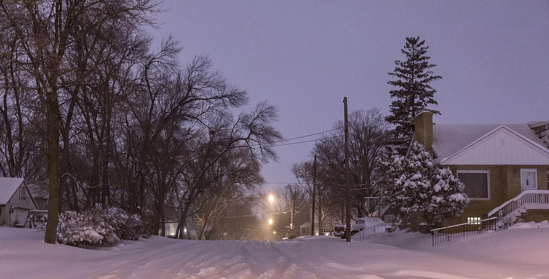 A snowy winter night on a residential street in Robbinsdale
