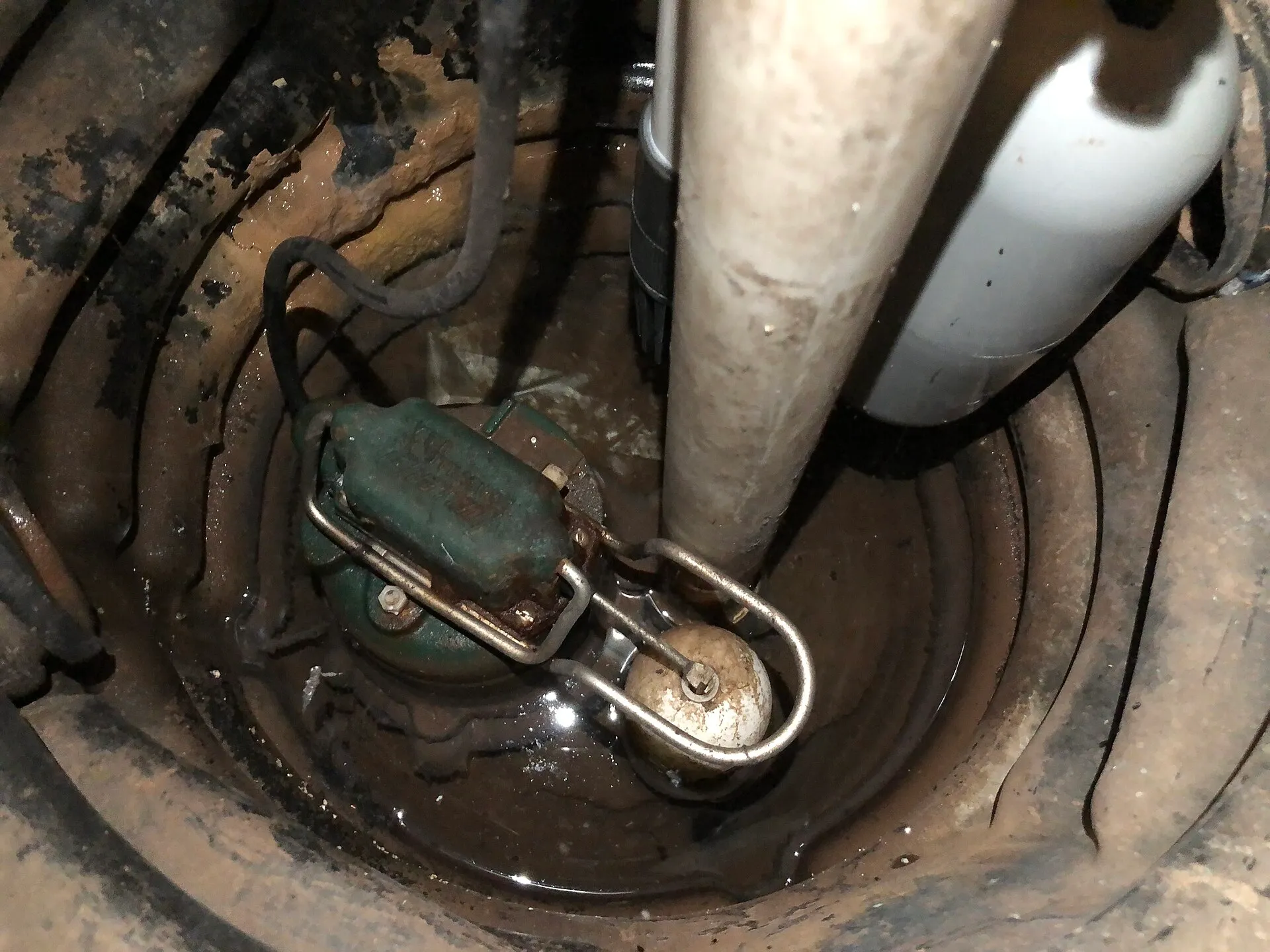 A sump pump installed in a basement pit